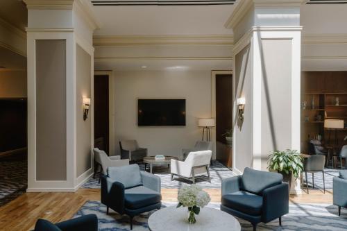 a lobby of a hotel with chairs and a table at Club Quarters Hotel Rittenhouse Square, Philadelphia in Philadelphia