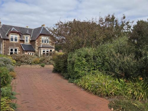 a brick road in front of a house at The Old Rectory in Largs