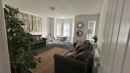 a living room with a couch and a table at Bright & Stylish 2 bed Flat, Great Location in Southampton