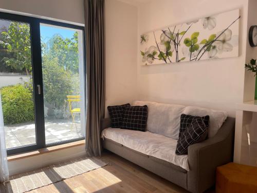a living room with a couch and a sliding glass door at House Garden in Bucharest