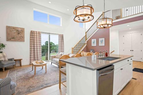 a kitchen and living room with a couch and a table at Dry Ridge Retreat - Near Ark - with Hot Tub in Dry Ridge