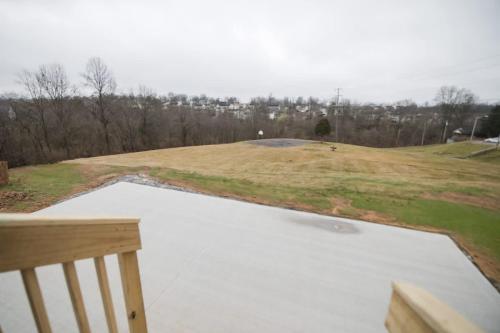 a view of a field from the balcony of a house at Dry Ridge Retreat - Near Ark - with Hot Tub in Dry Ridge