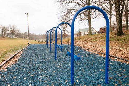 a row of blue bars on an empty playground at Dry Ridge Retreat - Near Ark - with Hot Tub in Dry Ridge
