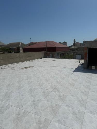 a large concrete patio with a building in the background at Rova Hotel in Baku