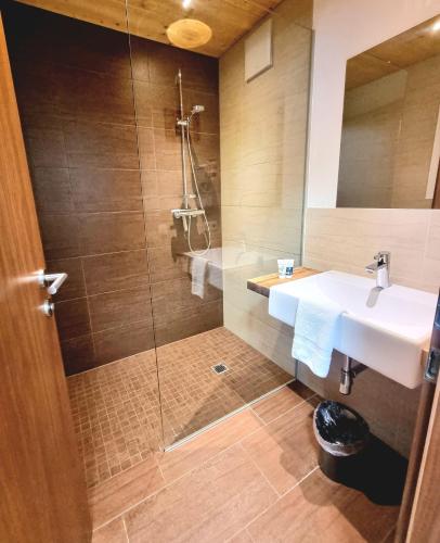 a bathroom with a sink and a shower at valbel in Sankt Anton am Arlberg