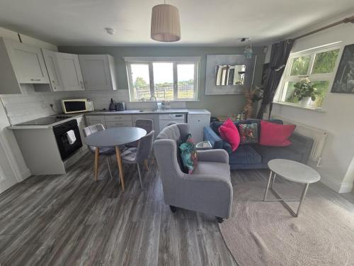 a living room with a couch and a table at Beautiful small home in Mallow