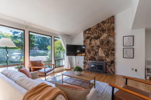 a living room with a couch and a fireplace at 5BR Gem Walk to Microsoft and Near Redmond DT in Redmond