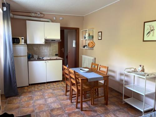 a kitchen and dining room with a table and chairs at La Vecchia Cantina in Stradella