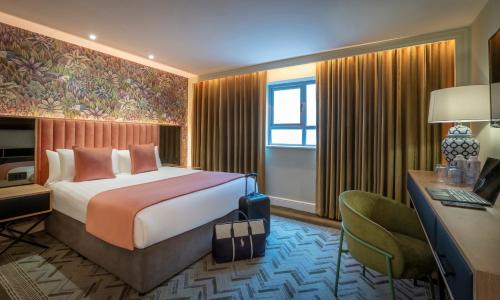 a hotel room with a bed and a desk and a computer at HYDE Hotel in Galway
