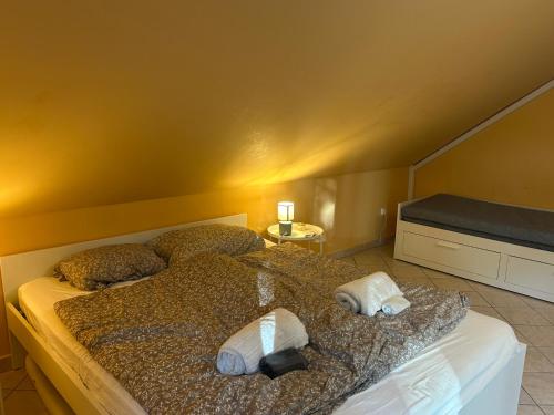 a bedroom with a bed with two towels on it at PatakLak Vendégház in Orfű