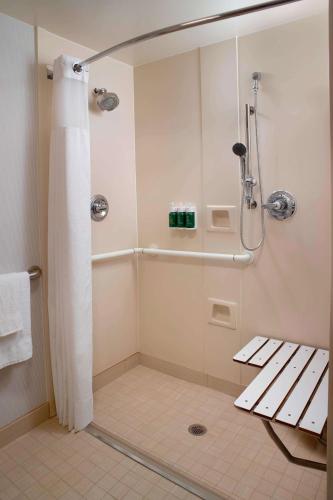 a shower with a shower curtain in a bathroom at Sonesta Select Atlanta Airport North in Atlanta