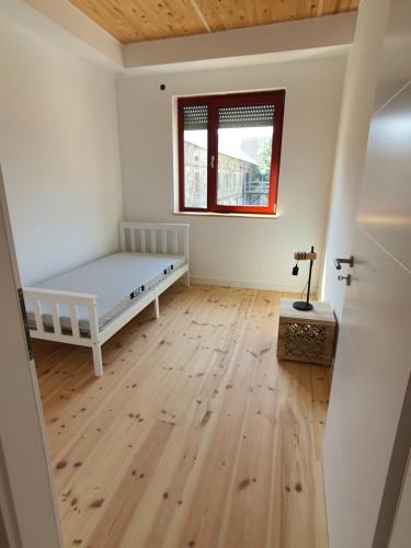 a bedroom with a bed and a wooden floor at Energiehof Liebon in Göda