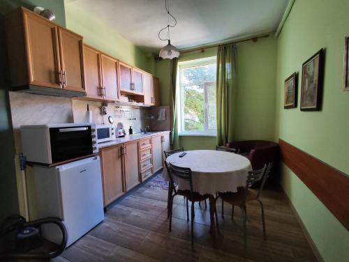 a kitchen with a table and a table and chairs at Podslon Varna Vibes in Varna City