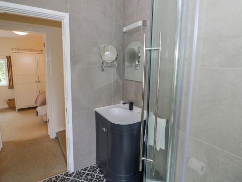 a bathroom with a sink and a shower at Hillside Cottage in Monmouth