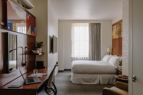 a hotel room with a bed and a desk at Club Quarters Hotel Rittenhouse Square, Philadelphia in Philadelphia