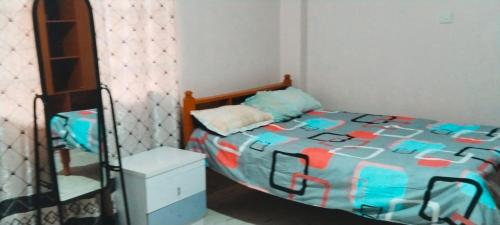 a small bedroom with a bed and a ladder at Flex Zone in Nairobi