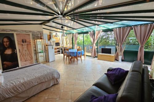 a bedroom with a bed and a couch in a room at Beautiful loft for 4 with large terrace 