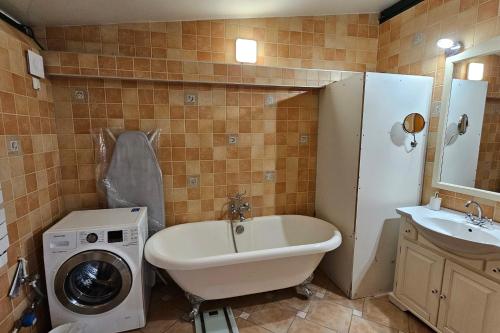 a bathroom with a washing machine and a sink at Beautiful loft for 4 with large terrace 
