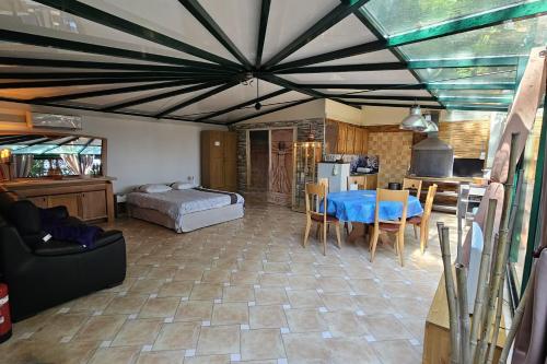 a living room with a blue table and a kitchen at Beautiful loft for 4 with large terrace 