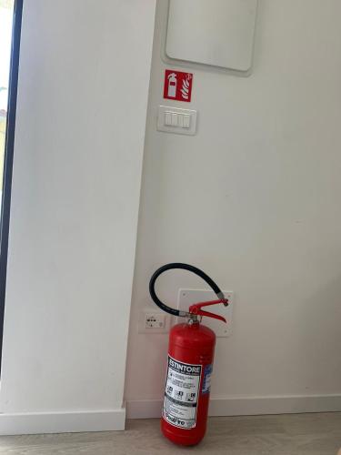 a red fire hydrant sitting in front of a door at Costa Trabocchi appartamento sul Mare in Fossacesia