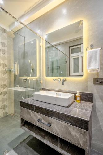 a bathroom with a sink and a mirror at Tree of Life Bed & Breakfast in New Delhi