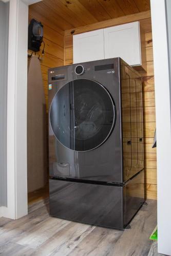 a washer and dryer sitting in a room at Priceless on Price St Walk to downtown! in Mount Airy