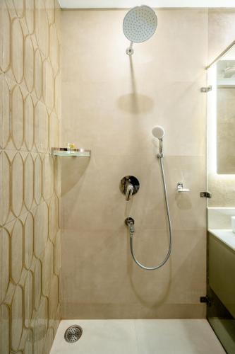 a bathroom with a shower with a shower head at Tree of Life Bed & Breakfast in New Delhi