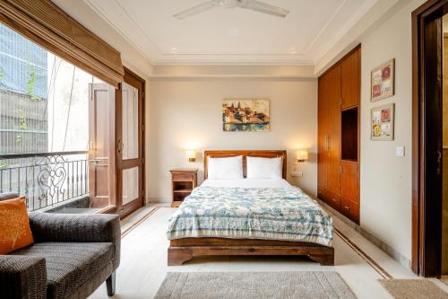 a bedroom with a bed and a balcony at Tree of Life Bed & Breakfast in New Delhi
