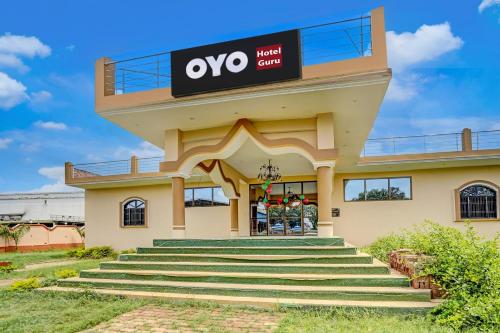 a building with a sign that reads oxo on it at Hotel O Guru in Jhūsi