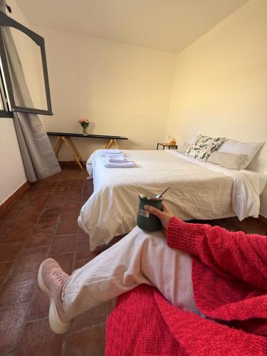 two beds in a room with a person laying on the floor at Clivias Hostel in Salta