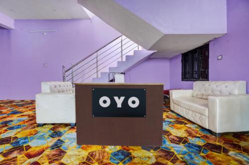 a room with two chairs and a table with an ovo sign at Hotel O Guru in Jhūsi