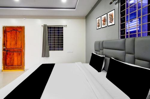 a bedroom with a bed and a couch and a door at Hotel O 5 Five Star in Upal