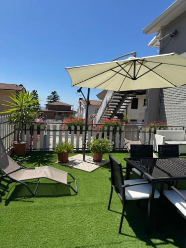 a patio with a table and chairs and an umbrella at Relaxing Home in Tignale