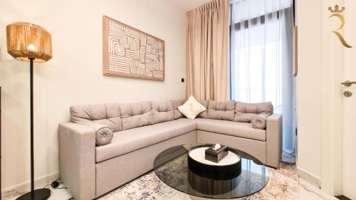 a living room with a couch and a table at Cozy 1BR Oasis - Luxe Chic Retreat in Abu Dhabi