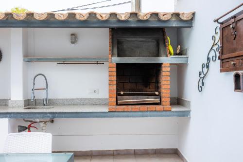 a kitchen with a brick oven in the wall at La Casita in Pollença