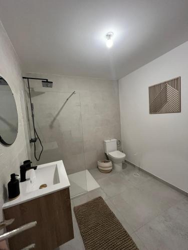 a bathroom with a sink and a shower and a toilet at Moment Home in Pia