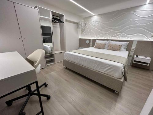 a bedroom with a bed and a desk in it at ANAVASI Loft SUITE in Alexandroupoli