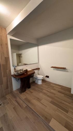 a bathroom with a sink and a toilet in a room at Arena Negraa in Mazunte