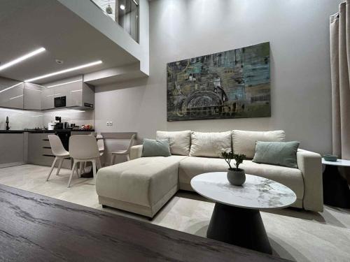 a living room with a couch and a table at ANAVASI Loft SUITE in Alexandroupoli