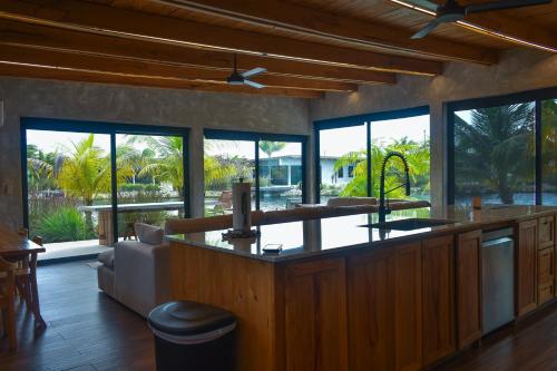a living room with a bar with a view of the ocean at Seabird - Villa 6 in Placencia Village