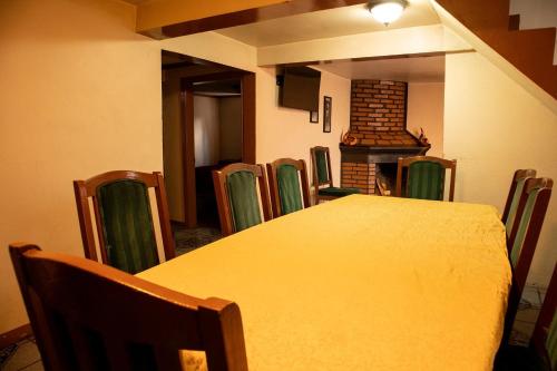 a dining room with a table and chairs and a fireplace at Hotel Doña Crucita in Creel