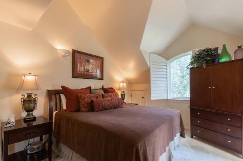 a bedroom with a bed and a dresser and a window at Beautiful Driggs Townhome with Views and Hot Tub in Driggs