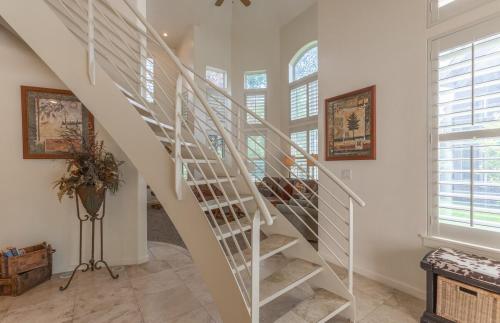 a white spiral staircase in a home with windows at Beautiful Driggs Townhome with Views and Hot Tub in Driggs