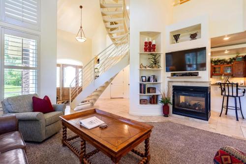 a living room with a fireplace and a staircase at Beautiful Driggs Townhome with Views and Hot Tub in Driggs
