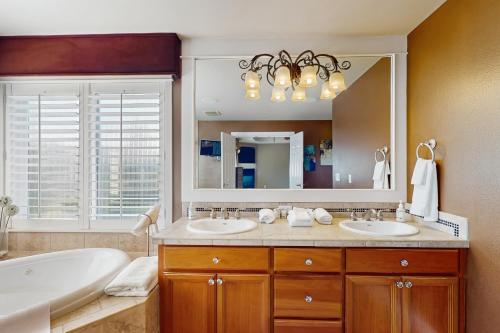 a bathroom with two sinks and a large mirror at Cascade Escape in Renton