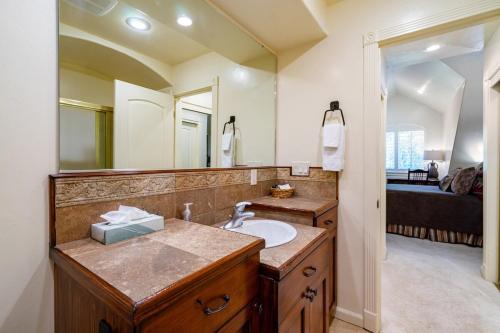 a bathroom with a sink and a large mirror at Beautiful Driggs Townhome with Views and Hot Tub in Driggs