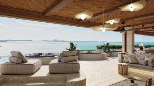 a patio with couches and a view of the ocean at Secrets Mirabel Cancún Resort & Spa in Cancún