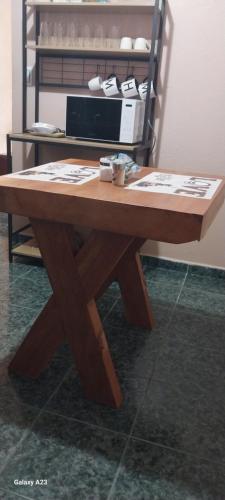 a wooden table sitting on top of a floor at Apartamentos equipados lc2 in Canoas