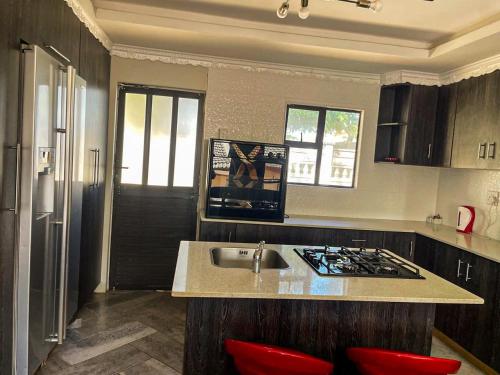 a kitchen with a sink and a counter top at 17 Zurich Drive House in Margate