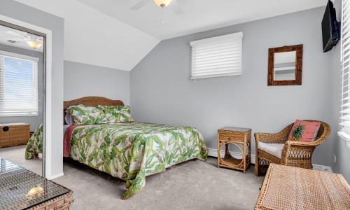 a bedroom with a bed and a chair and a mirror at Best Waterfront Retreat With Dock, Firepit, Bay in Seaside Heights